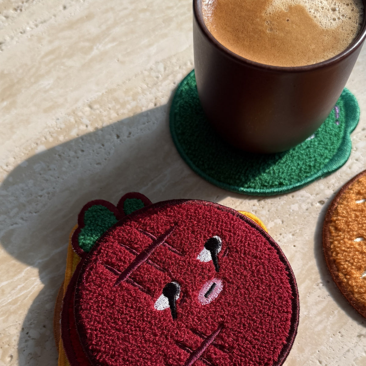Daging Burger Coaster Stack — patty coaster below a cup of coffee